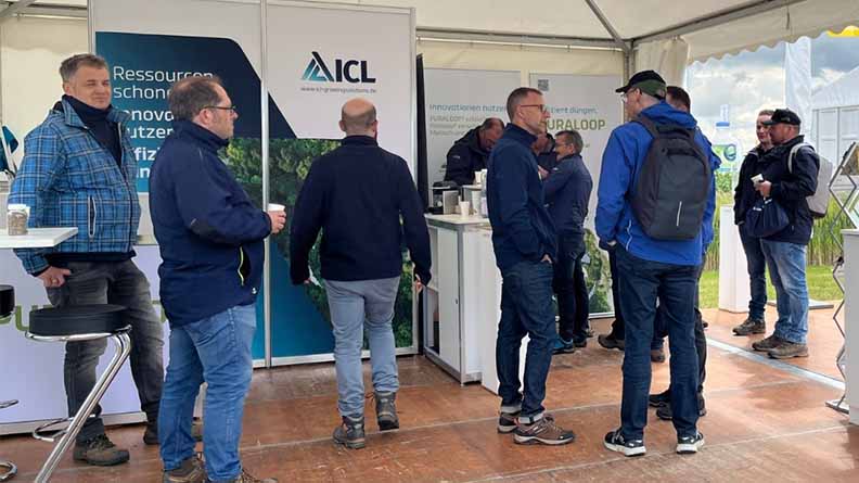 Visitors and agronomy experts at the ICL booth discussing sustainable fertilizer solutions and innovative plant nutrition technologies at an agricultural event.
