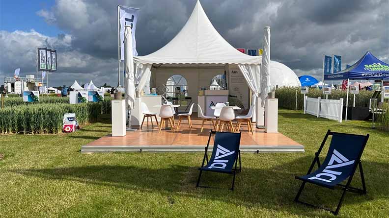 ICL exhibition tent at an agricultural fair featuring sustainable fertilizer solutions and crop innovation displays under cloudy skies.